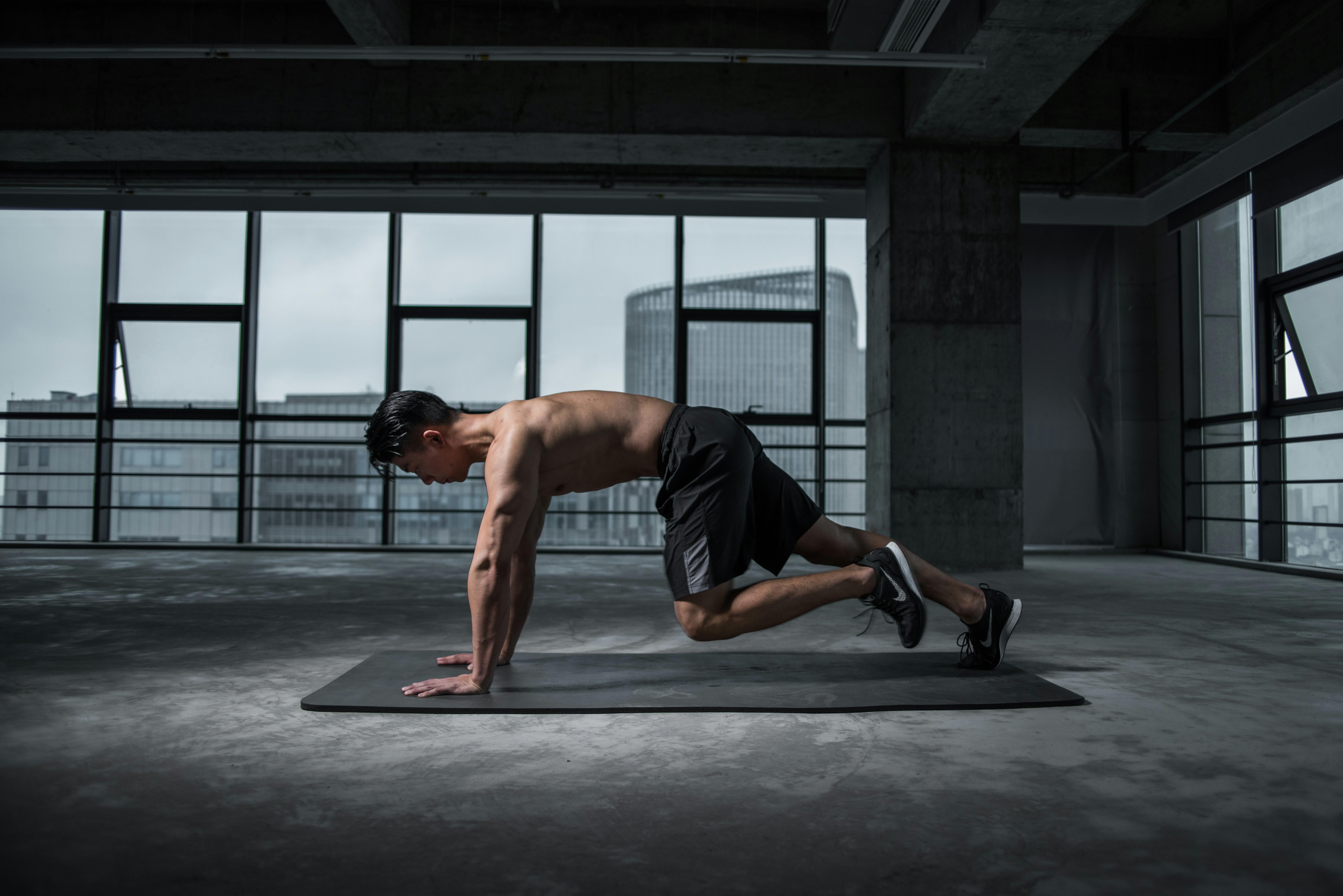 pexels-photo-2294361-2294361 Fit man doing mountain climbers exercise inside a modern gym